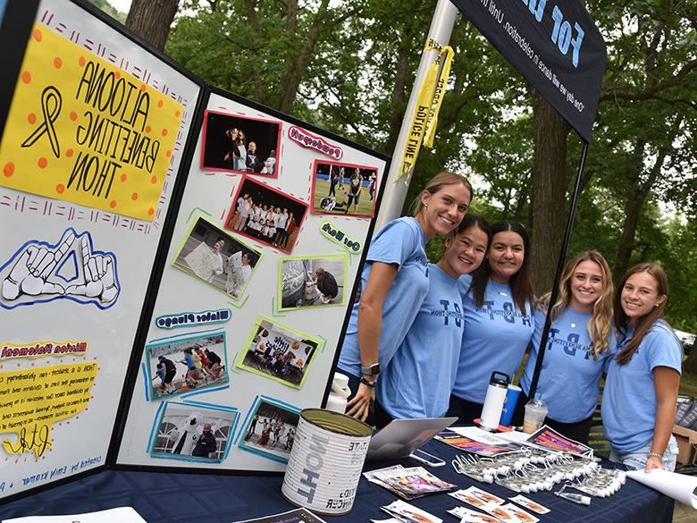 Female students at the THON booth during the Involvement Fair